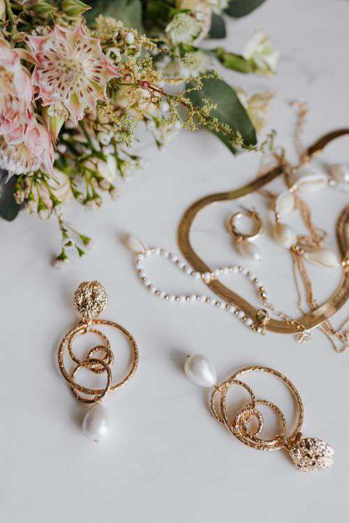 Gold jewelry on white marble