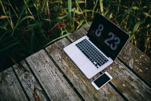 Man working on Macbook at lake