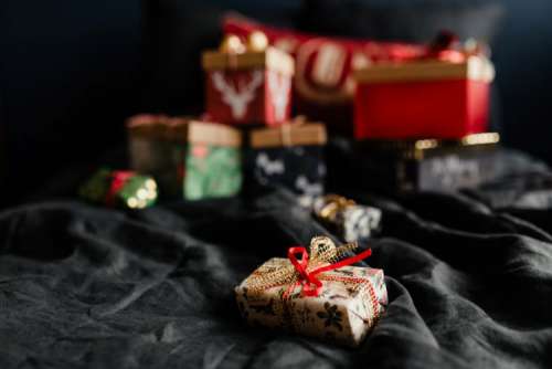 Christmas gifts on black linen bedding