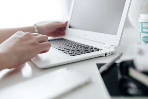 Workplace with laptop on table at home