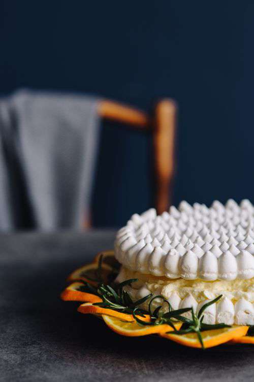 Meringue Cake with whipped cream and oranges