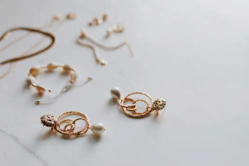 Gold jewelry on white marble