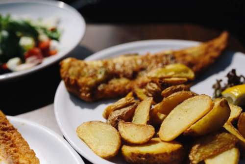 Dinner at reastaurant: Fish and Roasted Potatoes with Fresh Greek Salad