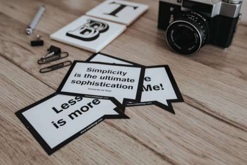 Little cards with inspirational quotes and a black camera