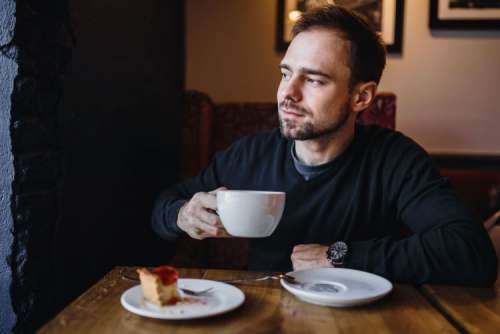 Young Elegantly dressed man sititng in a cafe