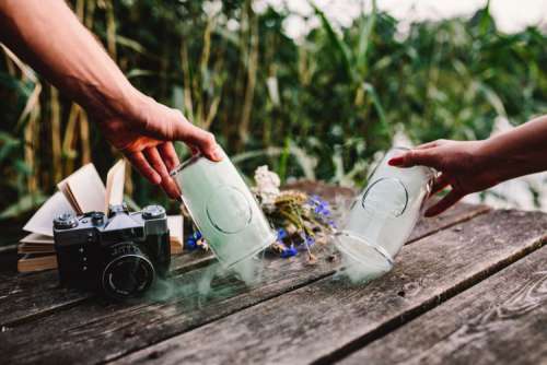 Colorful smoke bomb, book and vintage camera