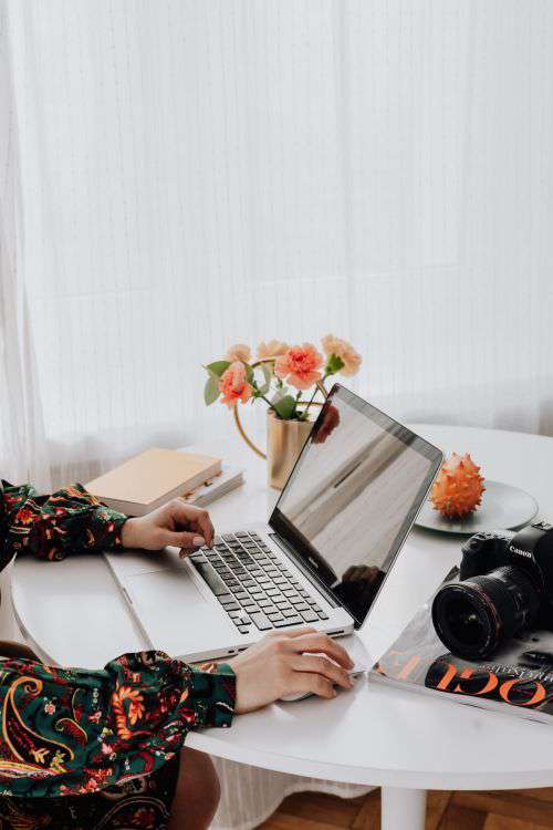 A woman works on a laptop at home