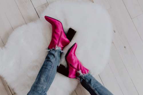 A woman in pink boots and blue jeans