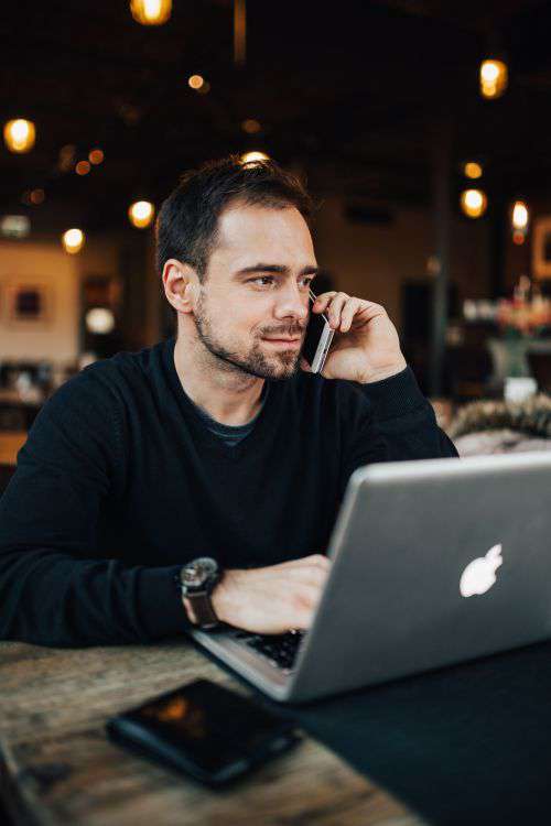 Young Entrepreneur Working from a Modern Cafe