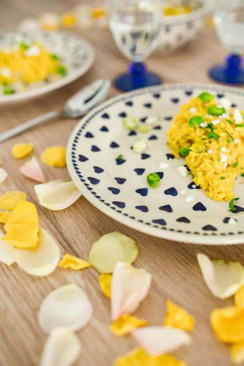 Risotto with broad bean on a cute plate with blue hearts