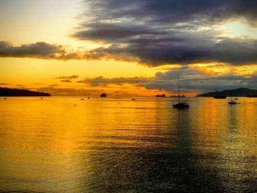 sunset golden sea bay clouds