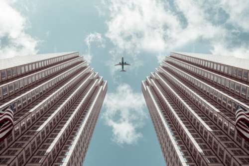 Airplane Between Buildings Free Photo