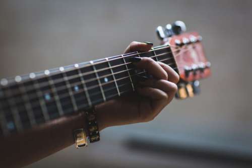Close Up Woman Playing Guitar Free Photo
