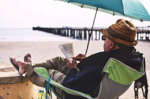 Man Chair Beach Book Sand Hat Free Photo