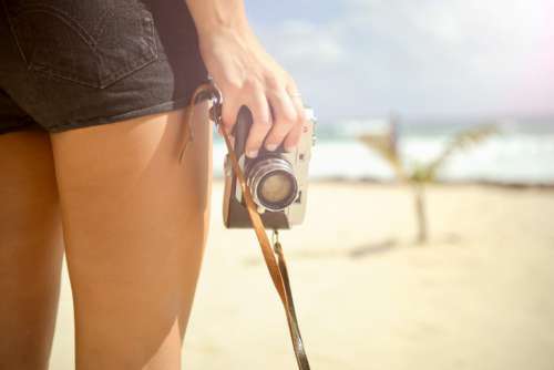 Woman on Beach and Vintage Camera Free Photo