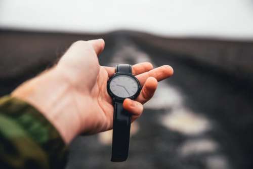 Holding Watch Outdoors Free Photo