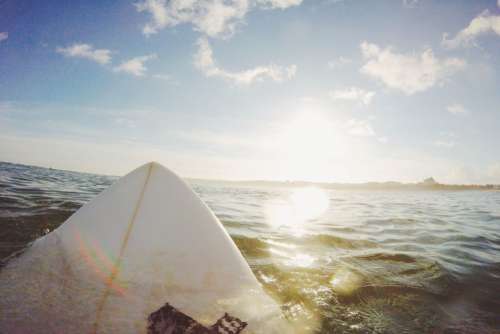 Surf Board Sea Water Blue Sky Clouds Free Photo