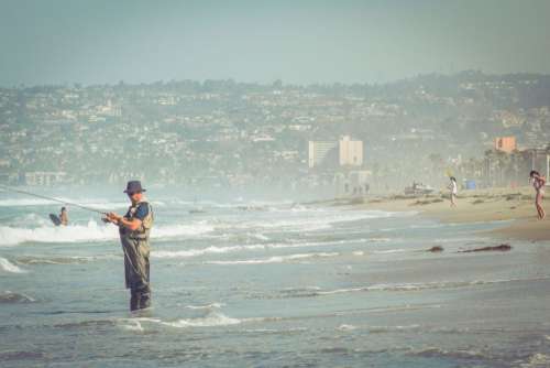 Man Fishing Fisherman Hat Beach Waves Sea Free Photo