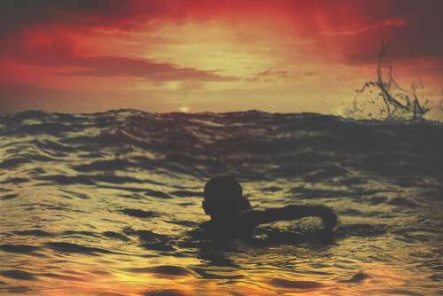 Boy Swimming Sea Dusk Free Photo