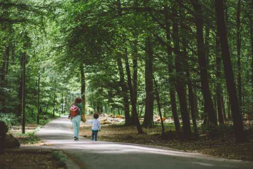 Woman and Child Walking in Park Free Photo