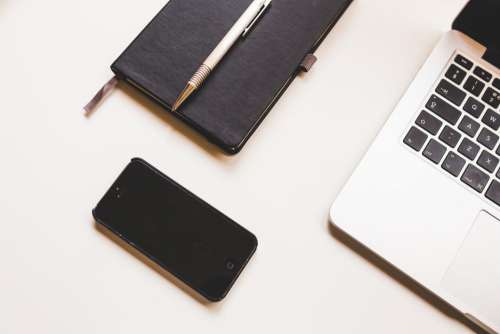 Black iPhone, MacBook & Notepad Free Photo
