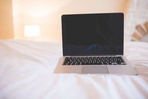 MacBook on Bed Free Photo