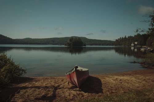 Canoe on Lake Shore Free Photo