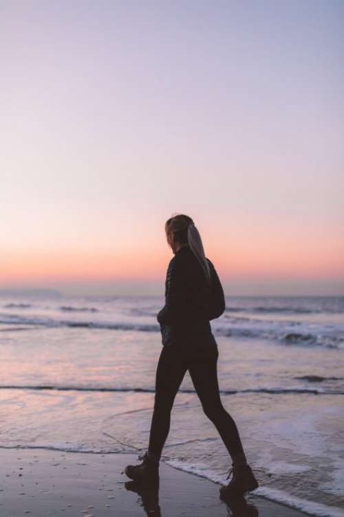 Woman Walking on Beach Free Photo