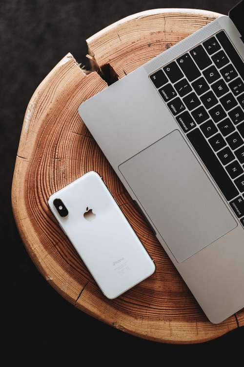 Modern Smartphone and Laptop on Wooden Table Free Photo