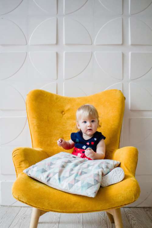 Baby on yellow chair