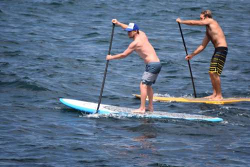 Two guys paddleboarding
