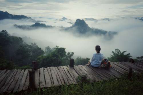Woman is looking the fog over mountain view of Mae Hong Son, Thailand.