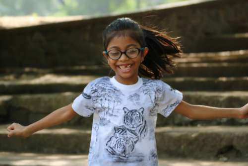 Girl child very happy having fun outdoors