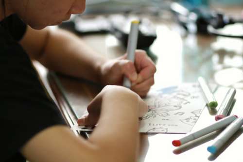 Young teenage girl drawing paper coloring relax at home.