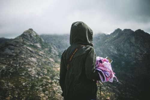 Millenial woman hiking in an inspirational moment. Adventure traveling.