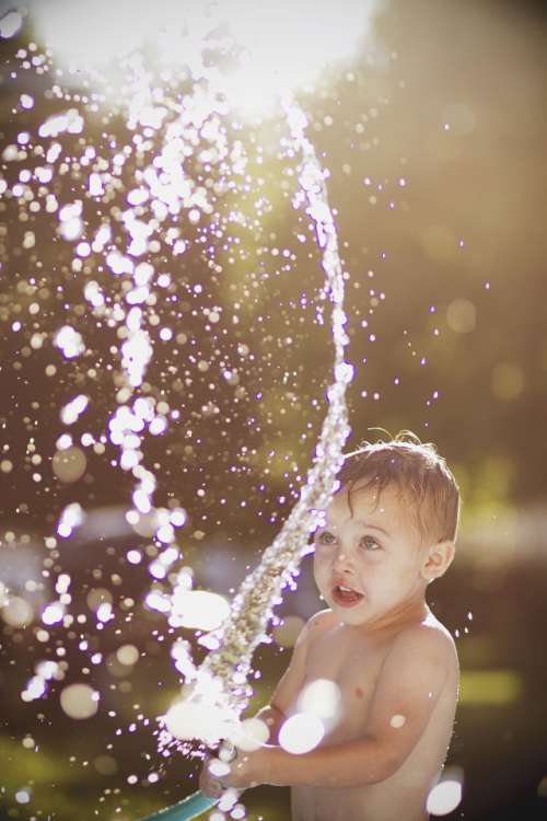 Little playing with the water hose summertime