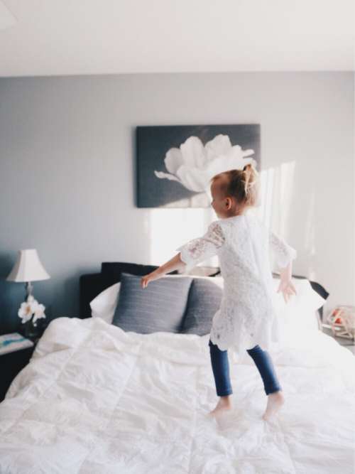 Girl jumping on bed 