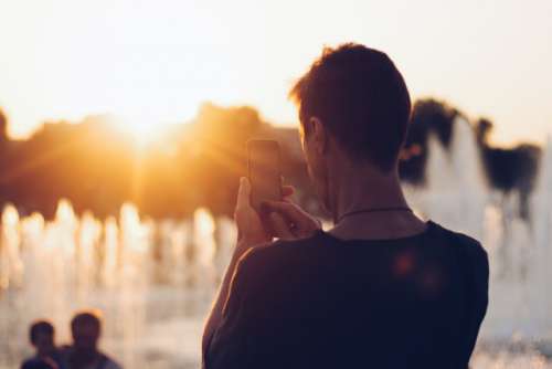The man takes photo on sunset 