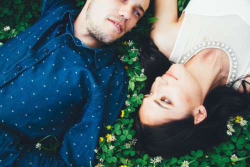 Couple lying on the juicy green grass