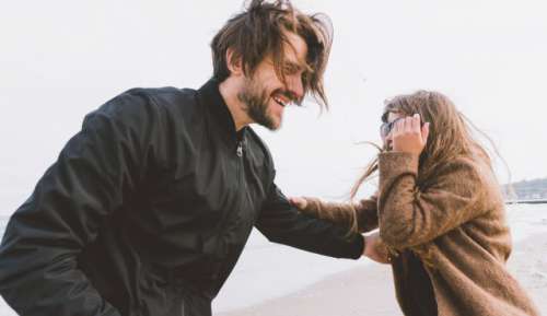 Happy Lovely couple on the windy seaside  