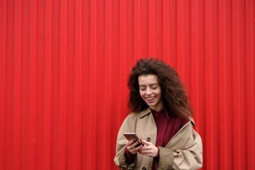 Smiling woman using mobile device 