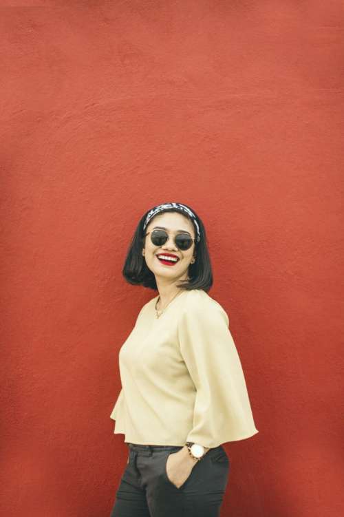 Summer Fashion Women in the red wall with smile