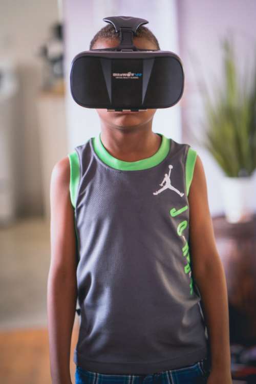 Little boy wearing virtual reality goggles