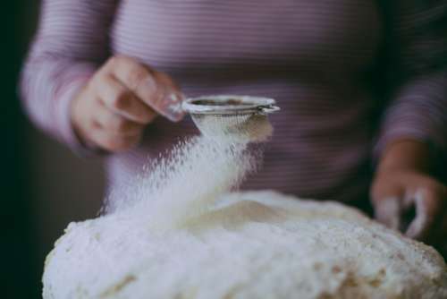 Homemade bread. Hands preparing bread dough on wooden table. 