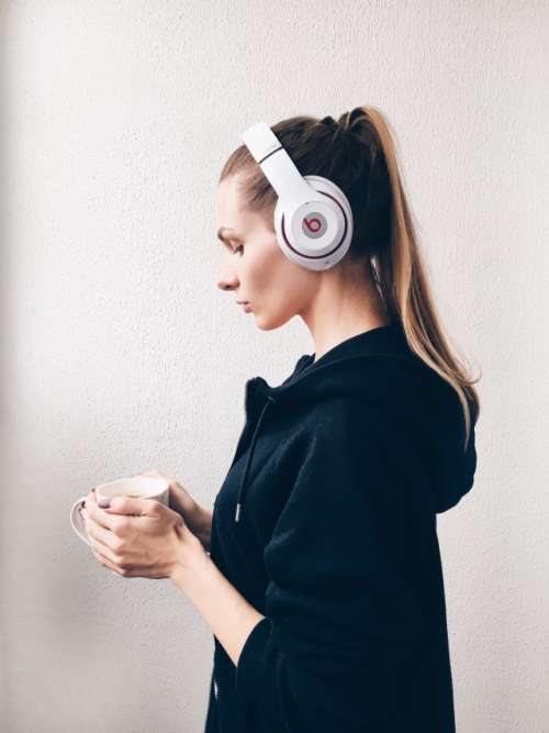 Girl is listening to music in headphones 