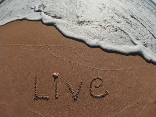 Live written in text on the shoreline 