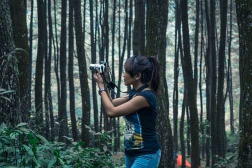 girl with camera on the forest