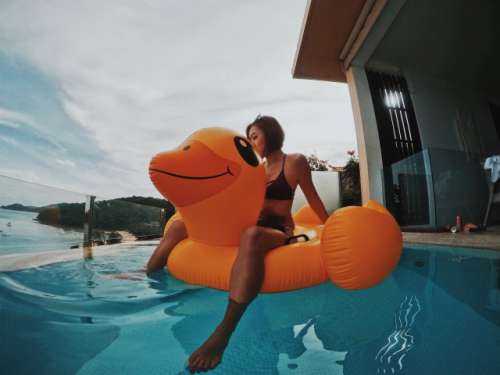 Woman sitting on a giant duck inflatable!