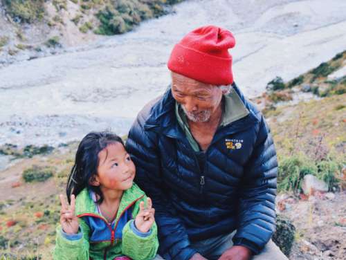 Grand father and little girl laughing in Nepal 