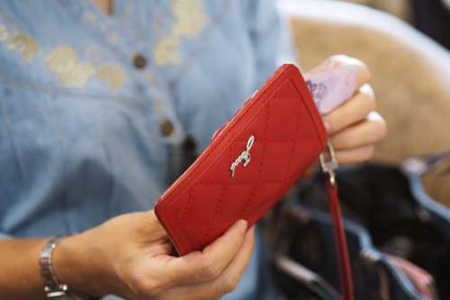 Woman and her red wallet on shopping retails